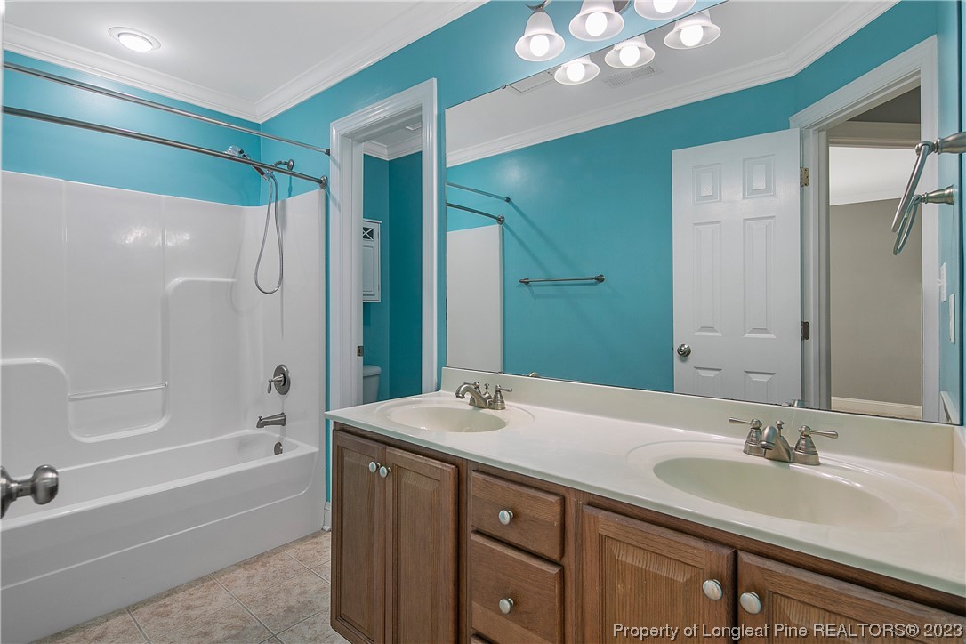 115 Blue Pine Drive Spring Lake, NC 28390 - Photo 29 of 48 a bathroom with a sink vanity granite tub shower and a mirror