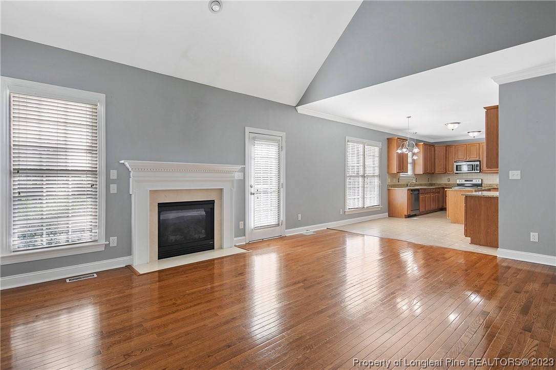 115 Blue Pine Drive Spring Lake, NC 28390 - Photo 8 of 48 a view of a kitchen with a fridge wooden floor and a window