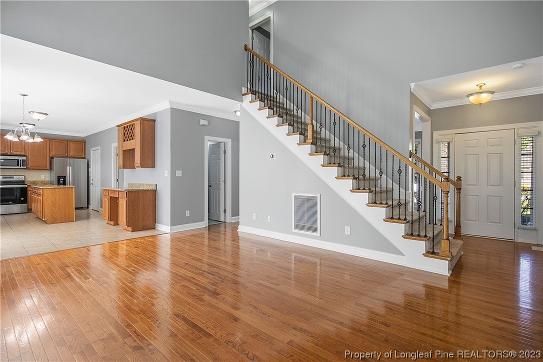 115 Blue Pine Drive Spring Lake, NC 28390 - Photo 9 of 48 a view of a hallway with wooden floor and dining room