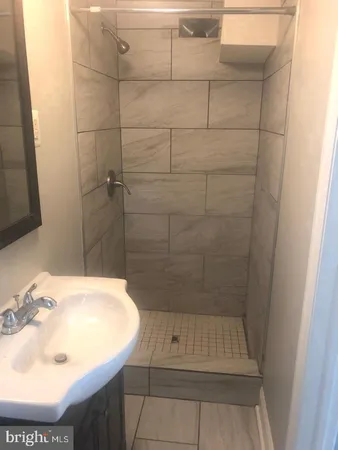a bathroom with a sink and shower