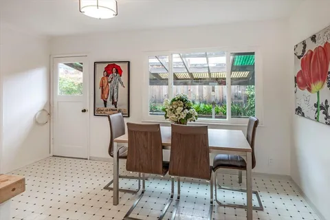 a dining room with furniture and window