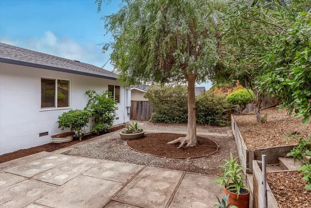 a wooden bench sitting in front of a house