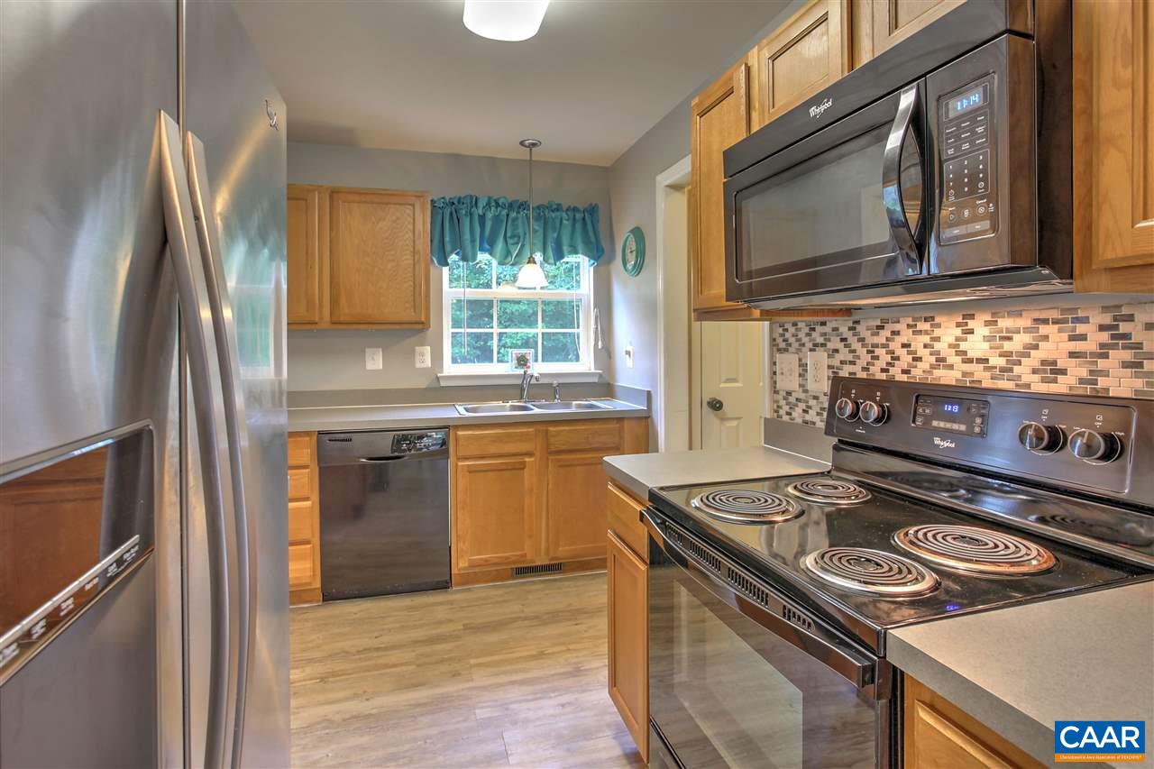 205 Jacoby Road Louisa, VA 23093 - Photo 6 of 21 a kitchen with stainless steel appliances granite countertop a stove a sink and a microwave
