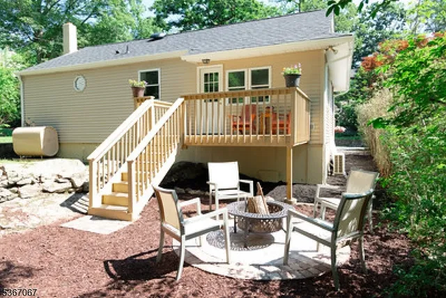 a view of a patio with table and chairs and potted plants