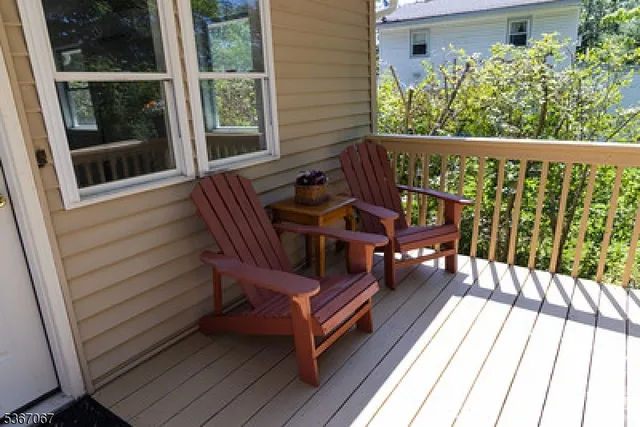 a view of a two chairs in the balcony