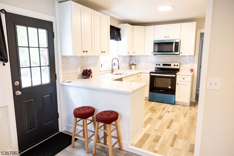 4 Bear Pond Trail Hopatcong, NJ 07821 - Photo 8 of 20 a kitchen with stainless steel appliances granite countertop a stove a sink dishwasher and a microwave