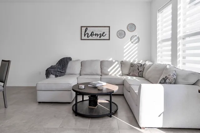 a living room with furniture and a large window