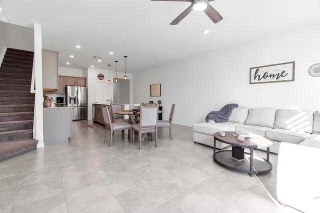 a living room with furniture and a dining table