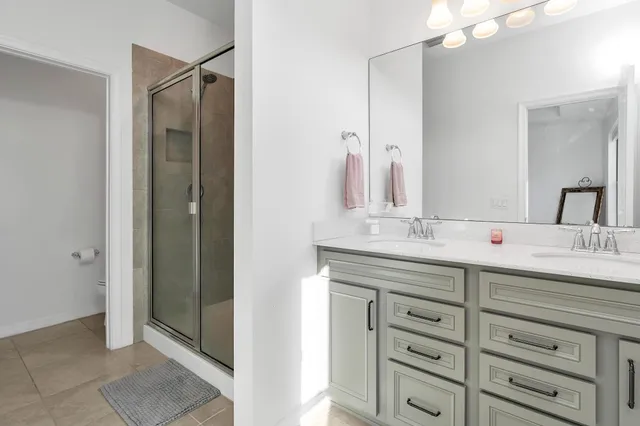 a bathroom with a double vanity sink and a mirror