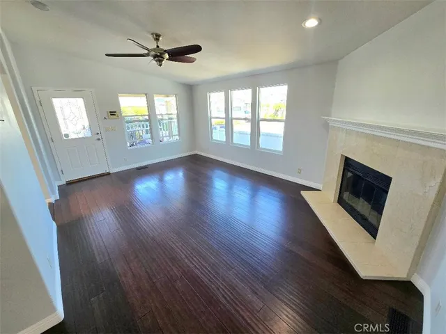 wooden floor in an empty room with a fireplace