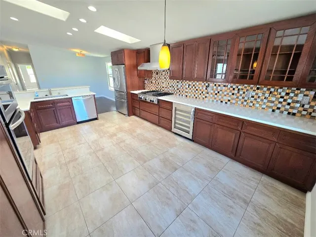 a kitchen with granite countertop wooden cabinets and stove