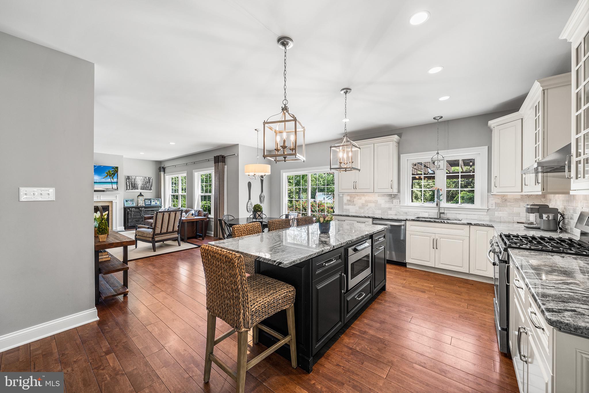 515 Old Eagle School Road Wayne, PA 19087 - Photo 10 of 40 a kitchen with granite countertop a stove a sink a counter space dining table and chairs