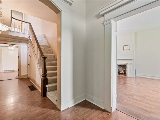 a view of entryway and hall with wooden floor