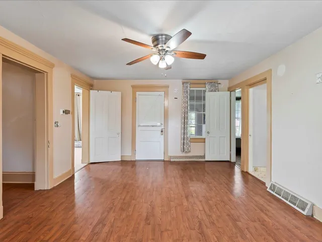 a view of an empty room with wooden floor