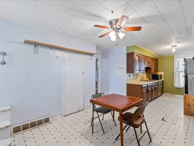 a view of a dining room with furniture and a chandelier