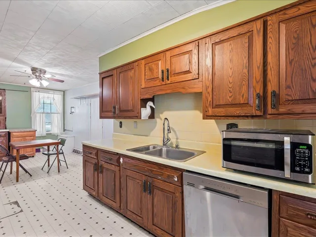 a kitchen with a stove a sink and a window