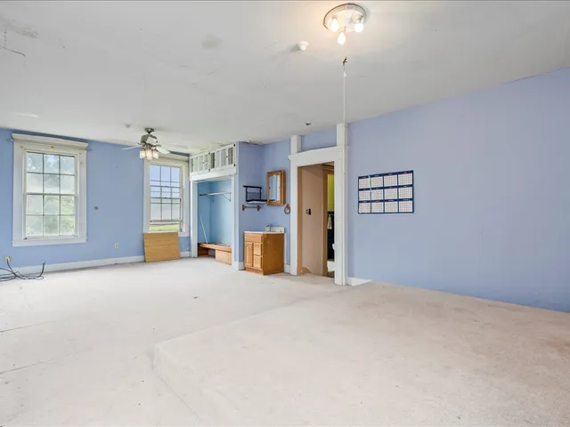 a spacious bedroom with a bed and a window