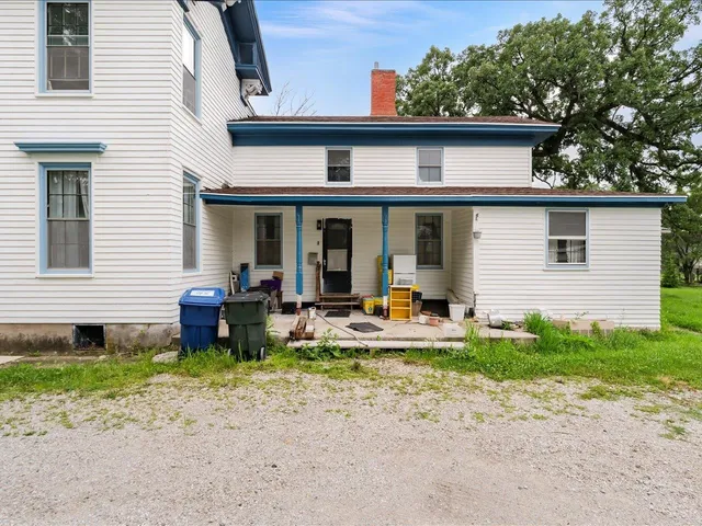 a view of a house with backyard sitting area and garden