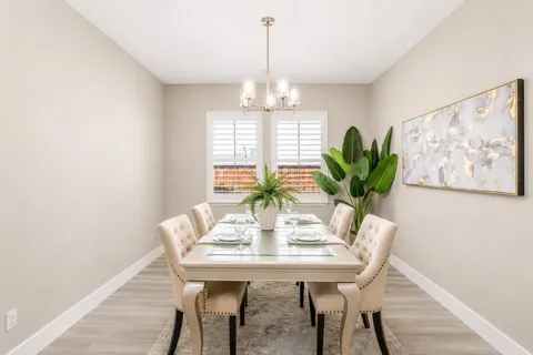 a dining room with furniture and window