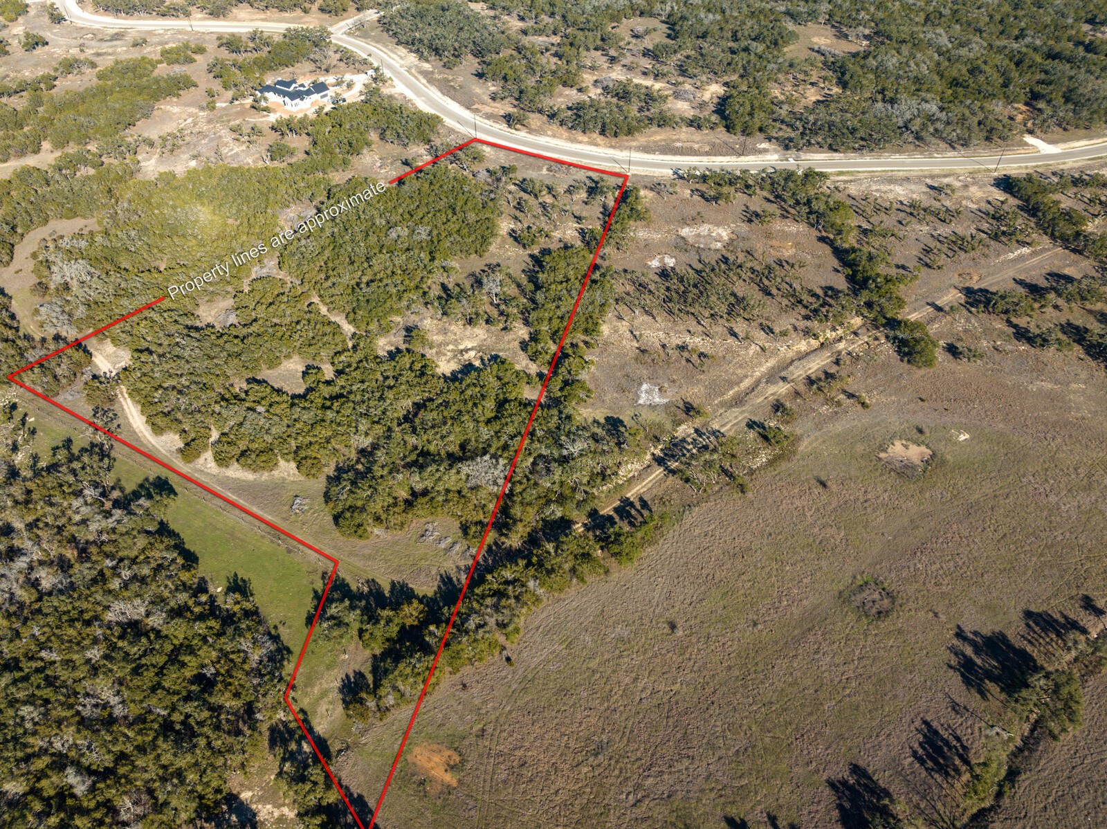 642 Windmill Ridge Drive Blanco, TX 78606 - Photo 1 of 29 a view of a dry yard with wooden fence