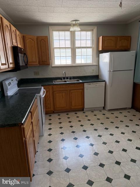 129 Ridge Avenue Waynesboro, PA 17268 - Photo 4 of 17 a kitchen with a sink a stove a microwave and a refrigerator