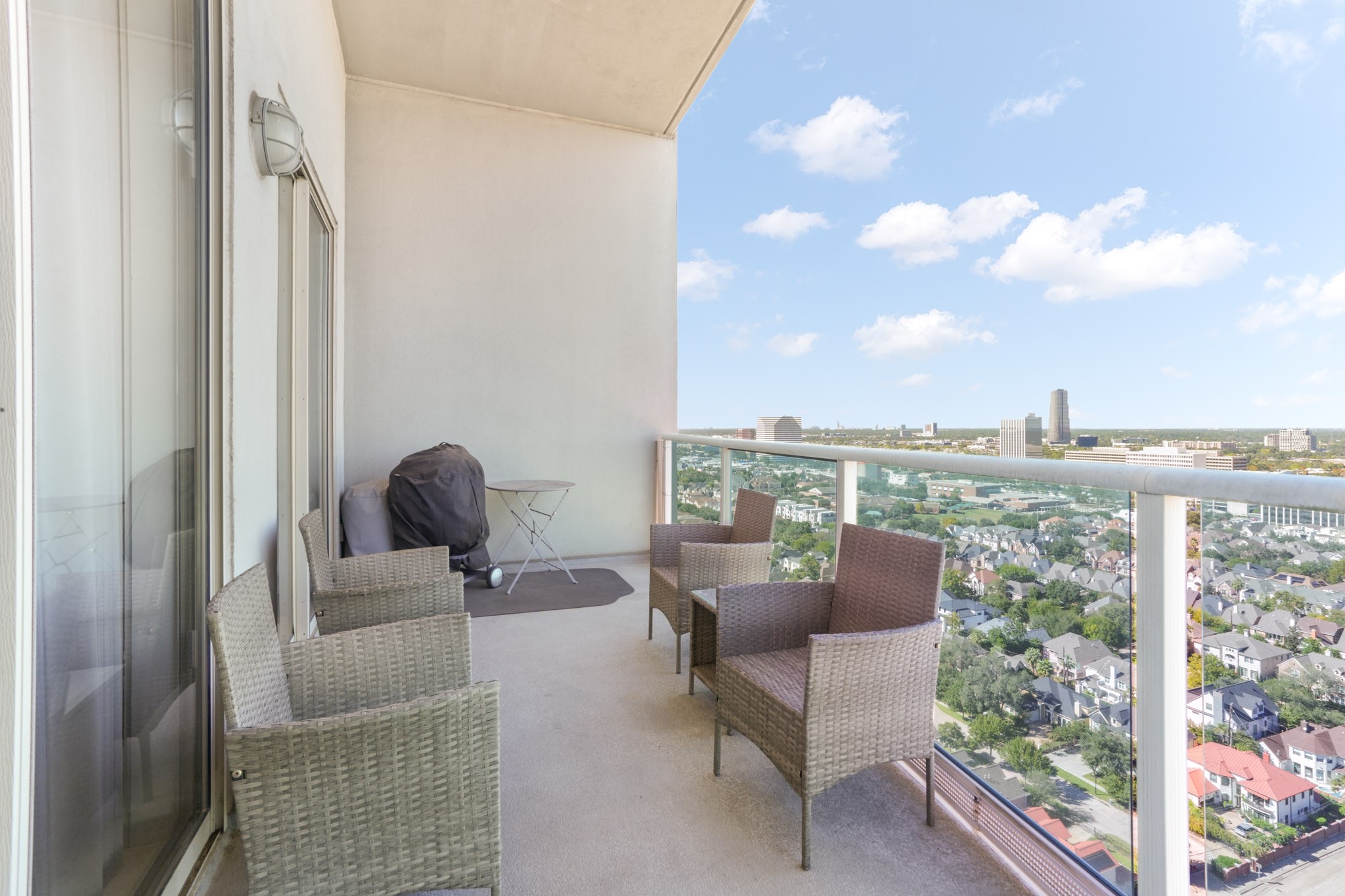 3388 Sage Road, Unit 2102 Houston, TX 77056 - Photo 2 of 21 a balcony with furniture and city view