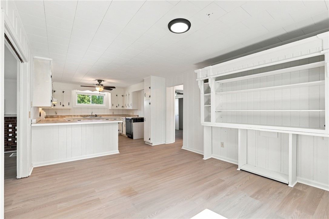 205 Timms Road Piedmont, SC 29673 - Photo 8 of 36 Gleaming wood-look floors anchor this open space featuring an expansive built-in shelving unit.