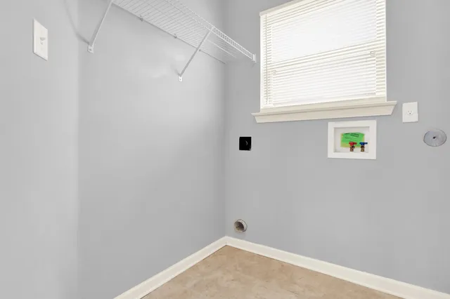 a kitchen with a cabinet a sink and a window