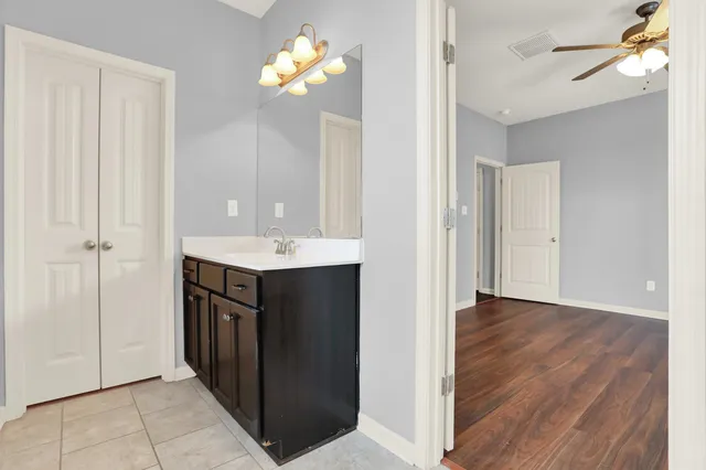 a bathroom with a sink vanity and a mirror
