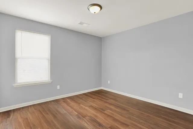 a view of an empty room and wooden floor