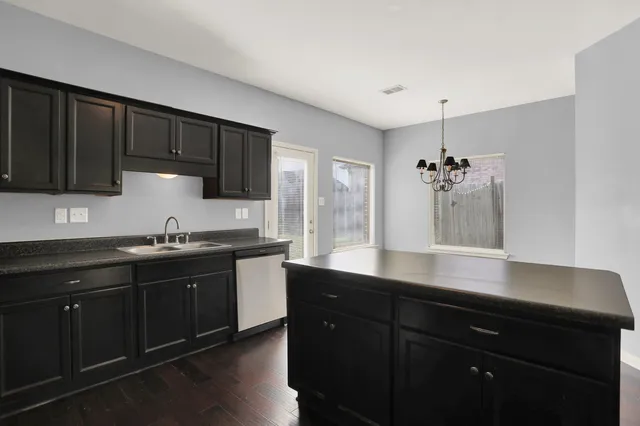 a kitchen with a sink and cabinets