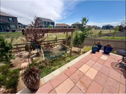 a view of a patio with couches and potted plants