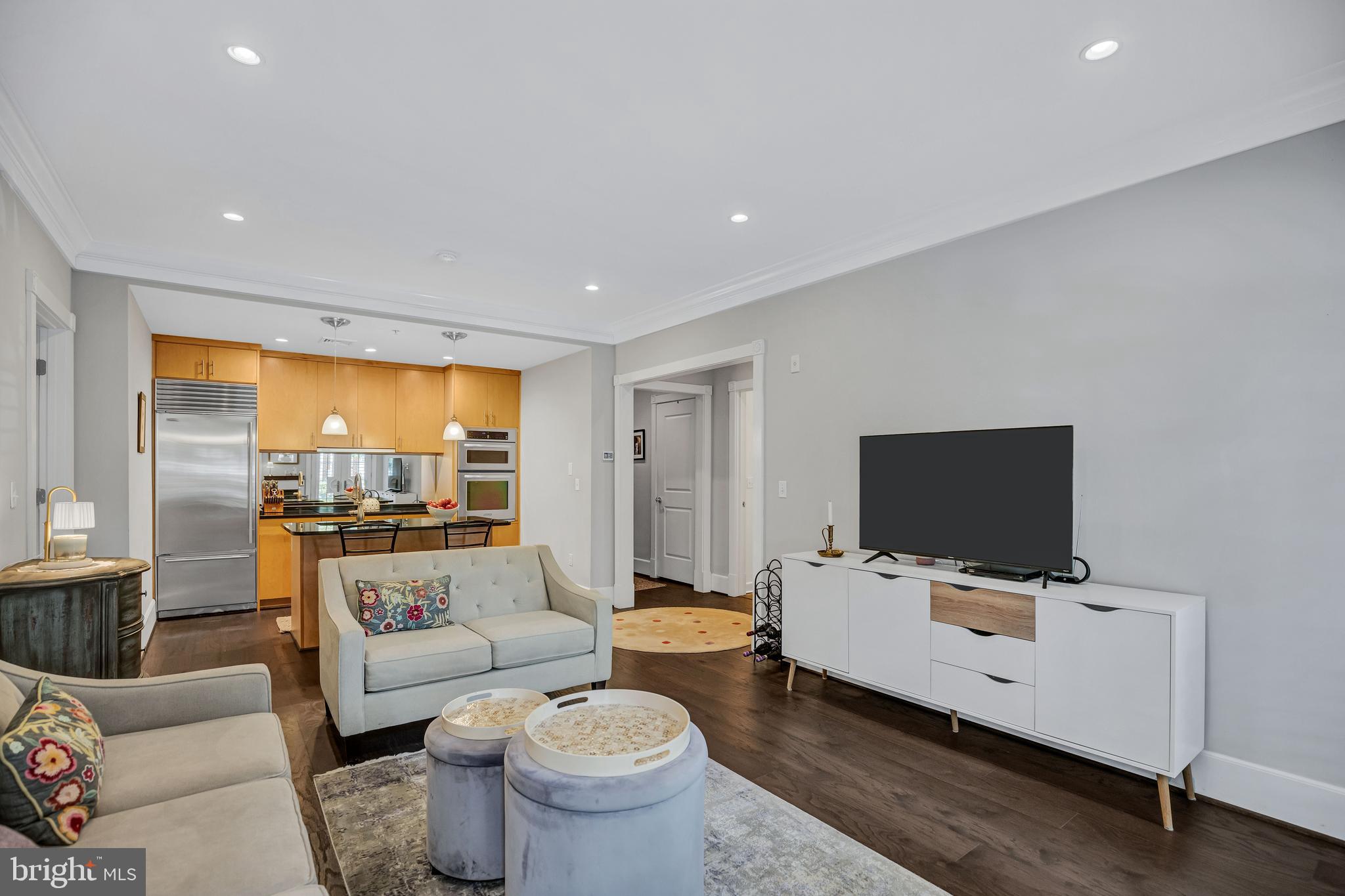 910 Powhatan Street, Unit 104N Alexandria, VA 22314 - Photo 12 of 60 a living room with furniture and a flat screen tv