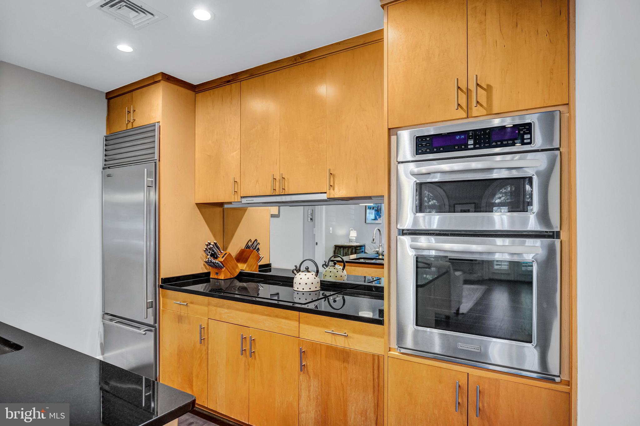 910 Powhatan Street, Unit 104N Alexandria, VA 22314 - Photo 17 of 60 a kitchen with stainless steel appliances a stove and a refrigerator