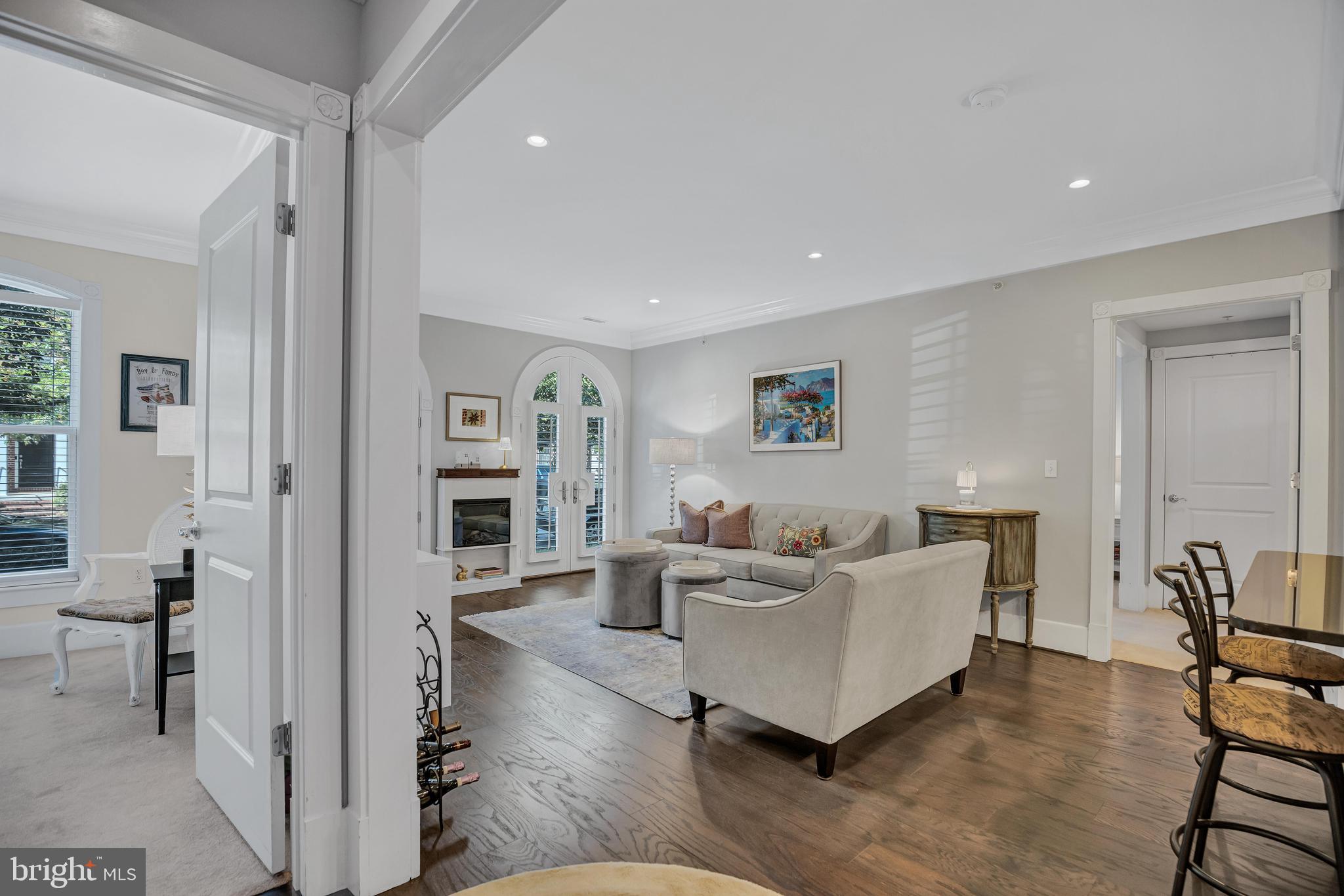 910 Powhatan Street, Unit 104N Alexandria, VA 22314 - Photo 60 of 60 a living room with furniture and a wooden floor