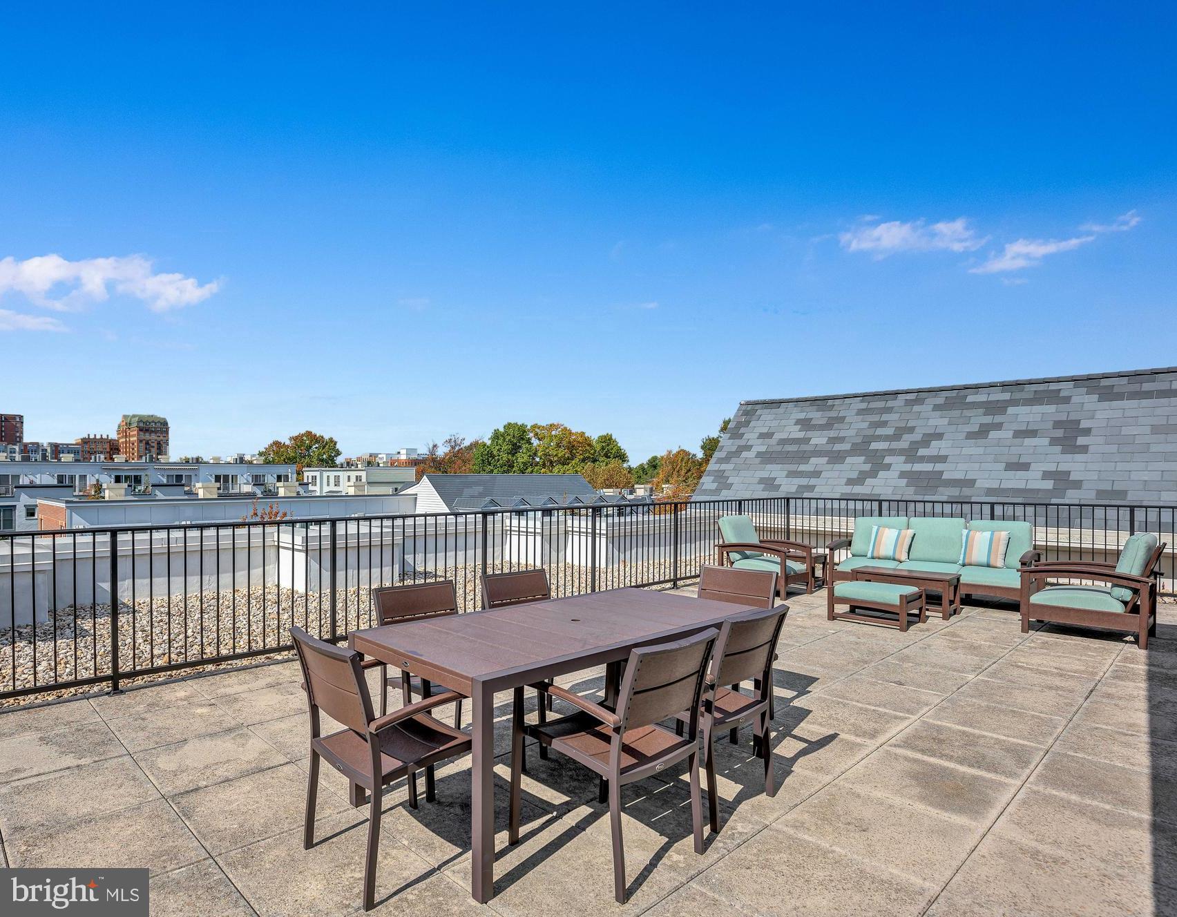 910 Powhatan Street, Unit 104N Alexandria, VA 22314 - Photo 30 of 60 a view of a patio with table and chairs