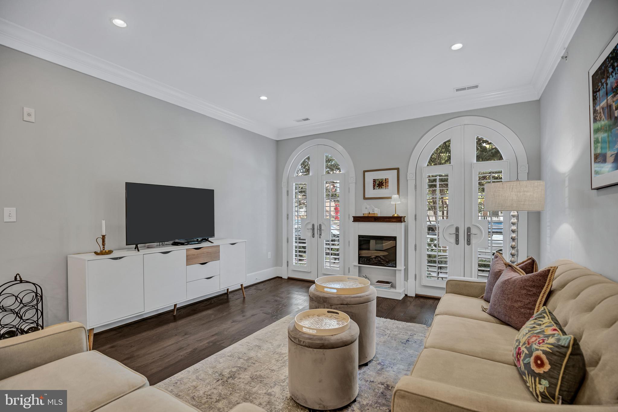 910 Powhatan Street, Unit 104N Alexandria, VA 22314 - Photo 9 of 60 a living room with furniture a fireplace and a flat screen tv