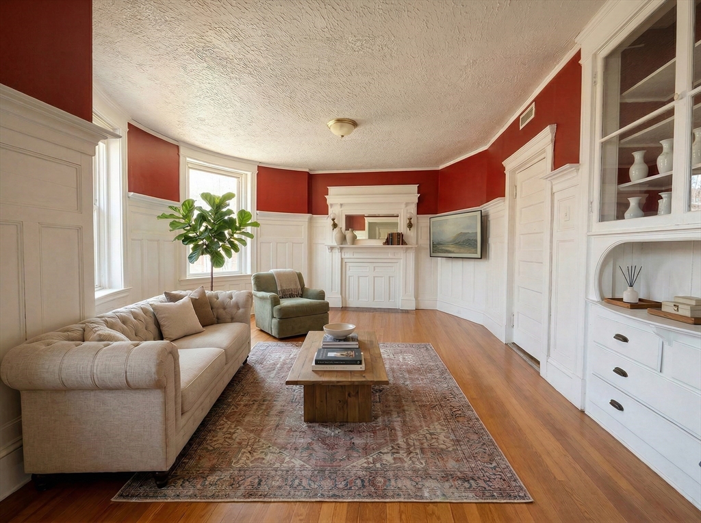a living room with furniture and a potted plant