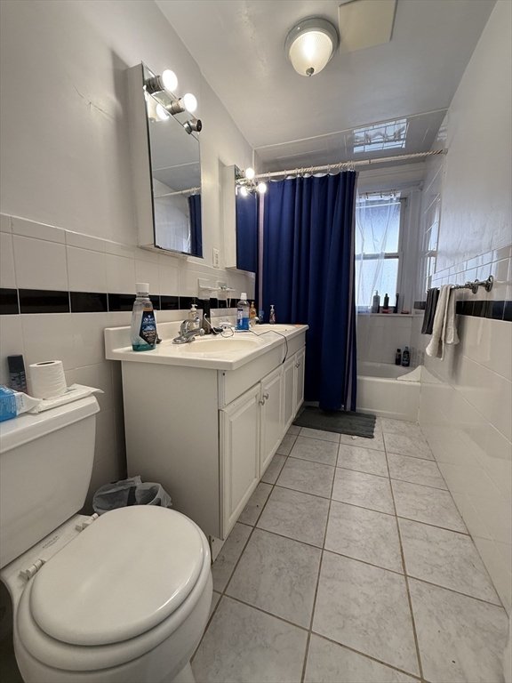 1908 Beacon Street, Unit 2 Brookline, MA 02445 - Photo 14 of 22 a bathroom with a sink a toilet and mirror