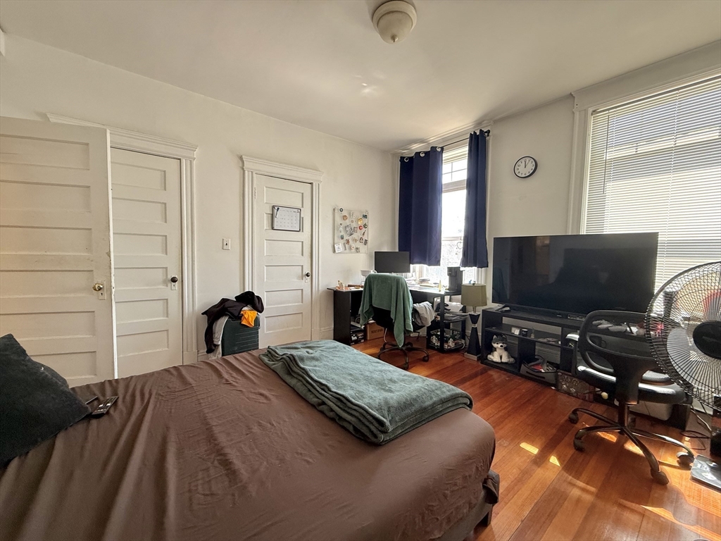 1908 Beacon Street, Unit 2 Brookline, MA 02445 - Photo 17 of 22 a bedroom with furniture and a flat screen tv