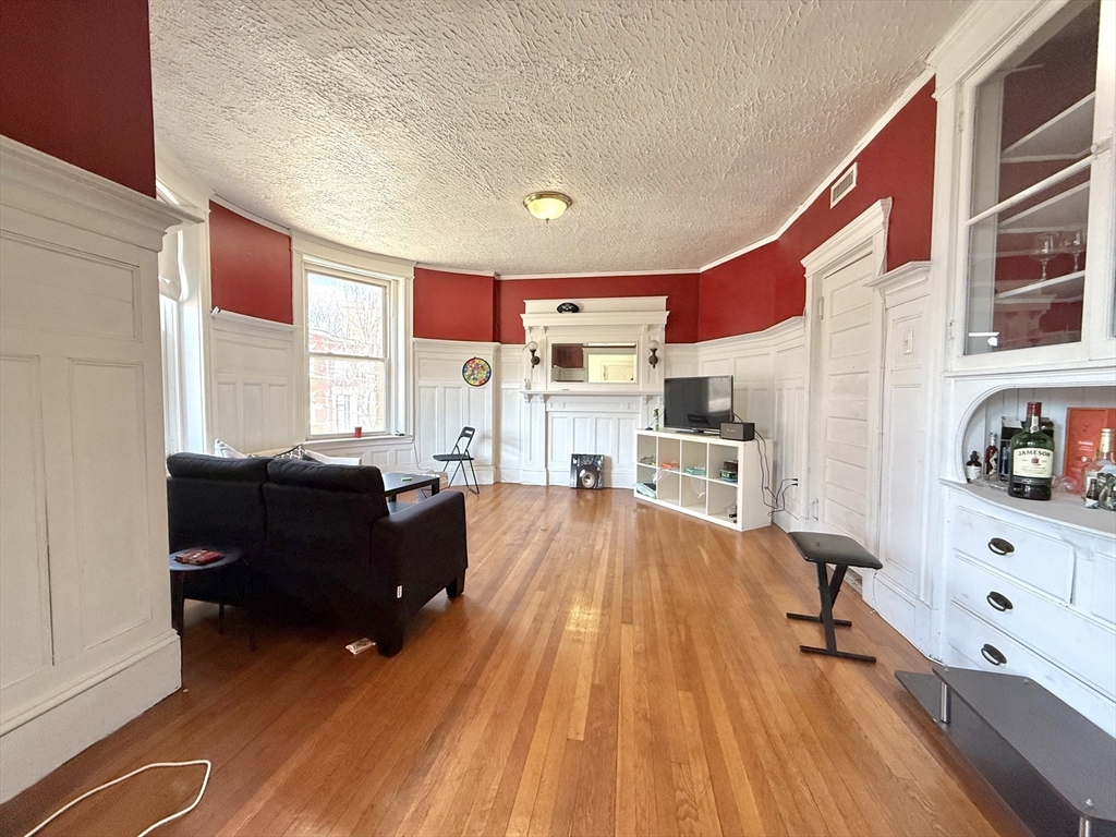 1908 Beacon Street, Unit 2 Brookline, MA 02445 - Photo 2 of 22 a living room with furniture and a wooden floor