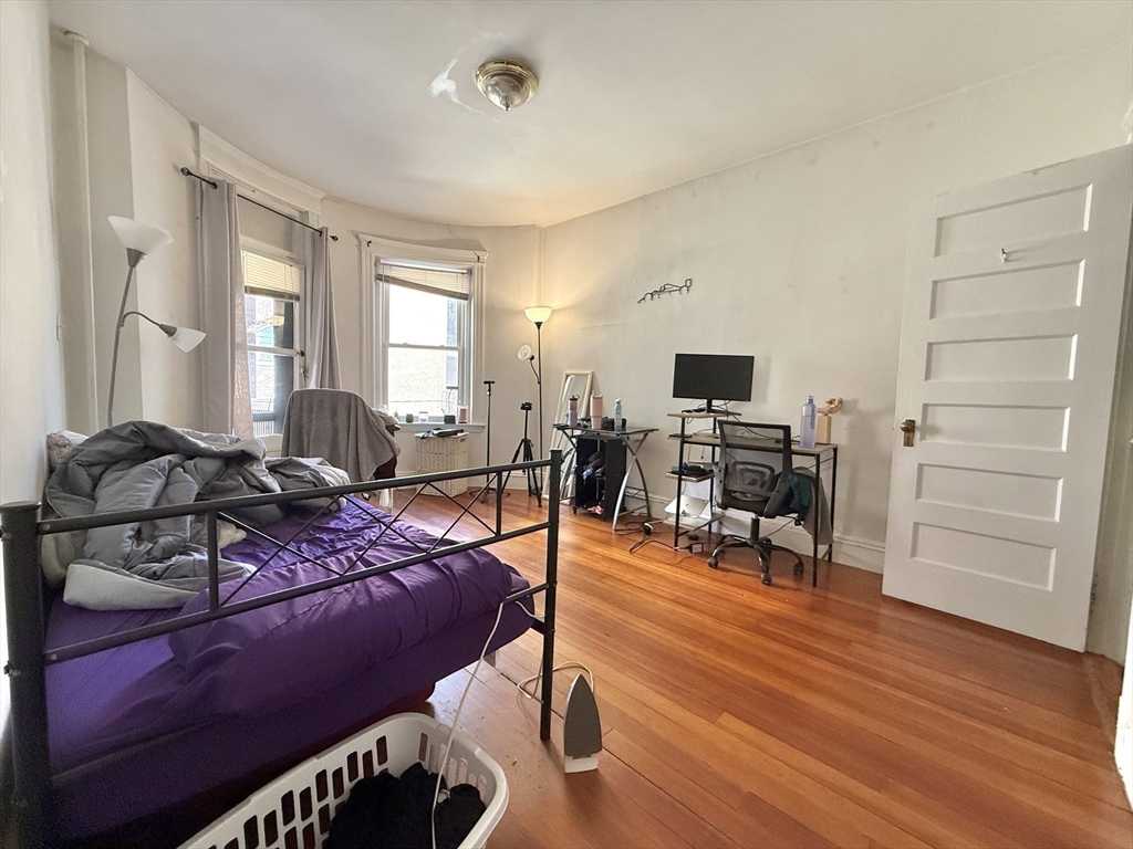 1908 Beacon Street, Unit 2 Brookline, MA 02445 - Photo 5 of 22 a bedroom with furniture a flat screen tv and a window
