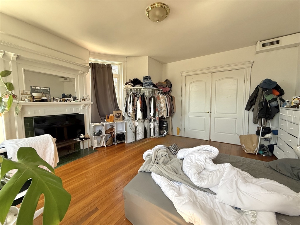 1908 Beacon Street, Unit 2 Brookline, MA 02445 - Photo 7 of 22 a bedroom with a bed and a mirror