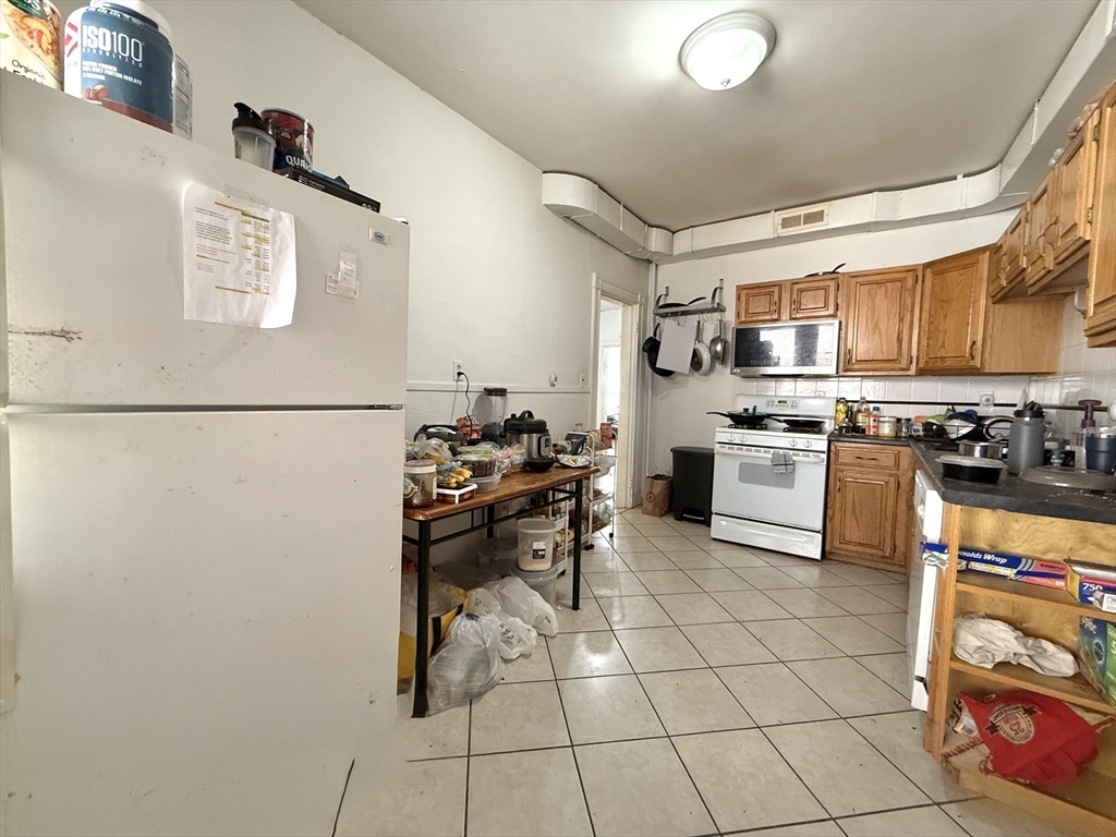 1908 Beacon Street, Unit 2 Brookline, MA 02445 - Photo 8 of 22 a kitchen with granite countertop cabinets and appliances