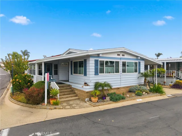 a front view of house with yard outdoor seating and barbeque oven