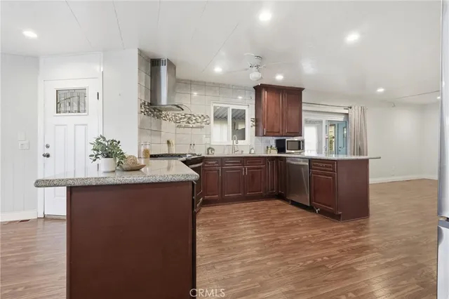 a kitchen with stainless steel appliances granite countertop a sink and cabinets