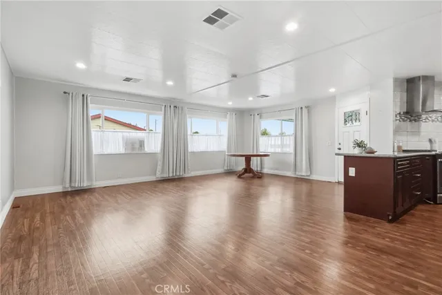 a kitchen with stainless steel appliances granite countertop a sink stove and wooden floor