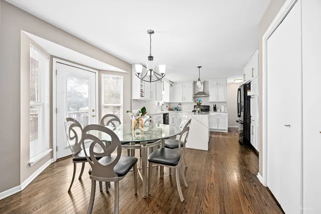 a view of a dining room with furniture and wooden floor