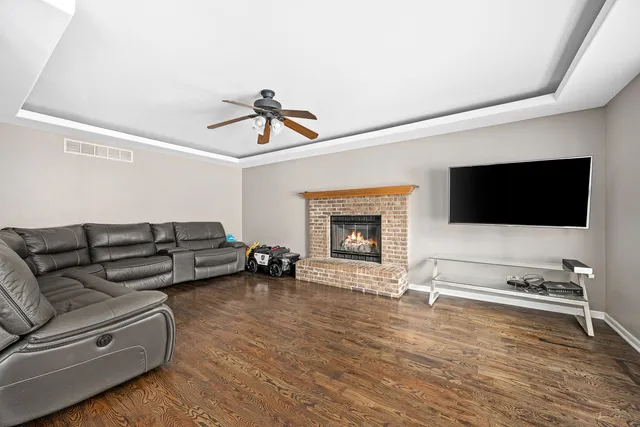 a living room with furniture flat screen tv and a fireplace