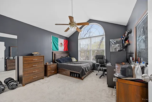 a bedroom with furniture and a large window